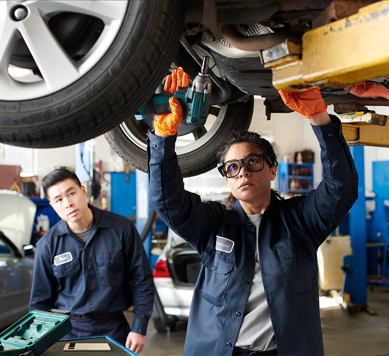 two people working in a car garage